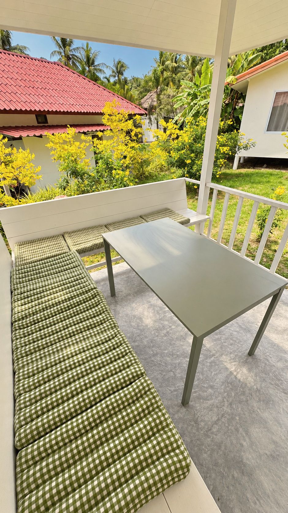 Terrace table and woven cushions on the veranda