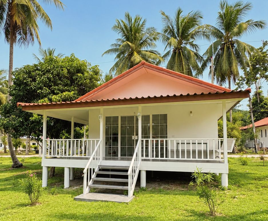 Elevated bungalow with veranda and steps beneath coconut palms