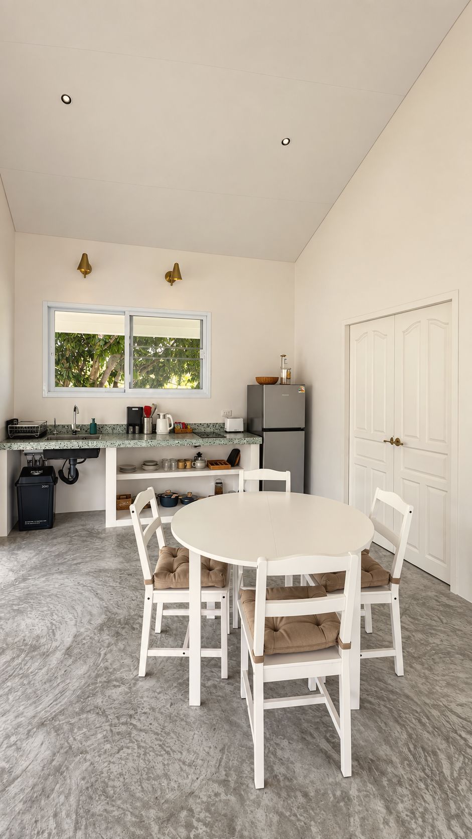 Kitchen and dining table under a vaulted ceiling