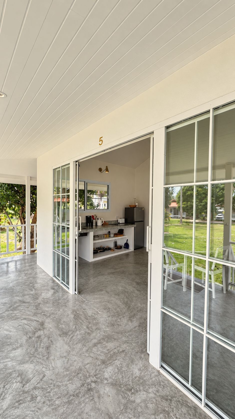 Glass doors opening from the living room to the veranda