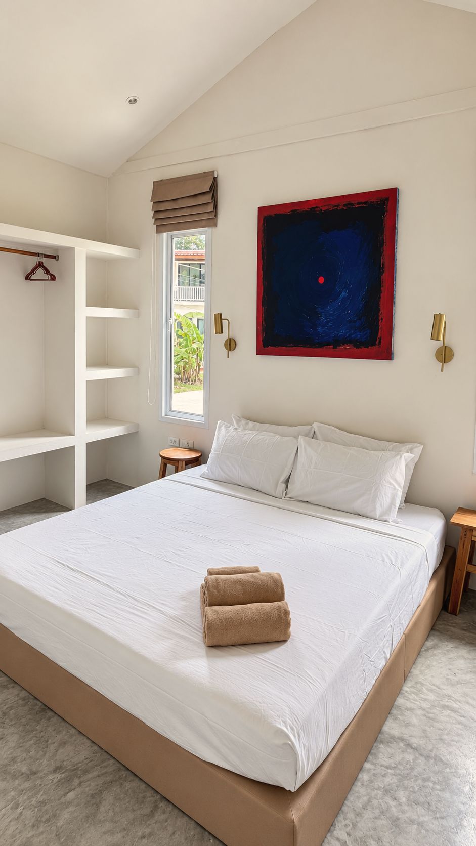 Bedroom with an indigo and red canvas above the bed