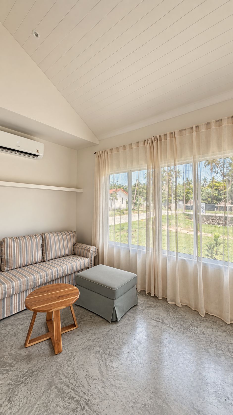 Sofa by the window with sheer curtains