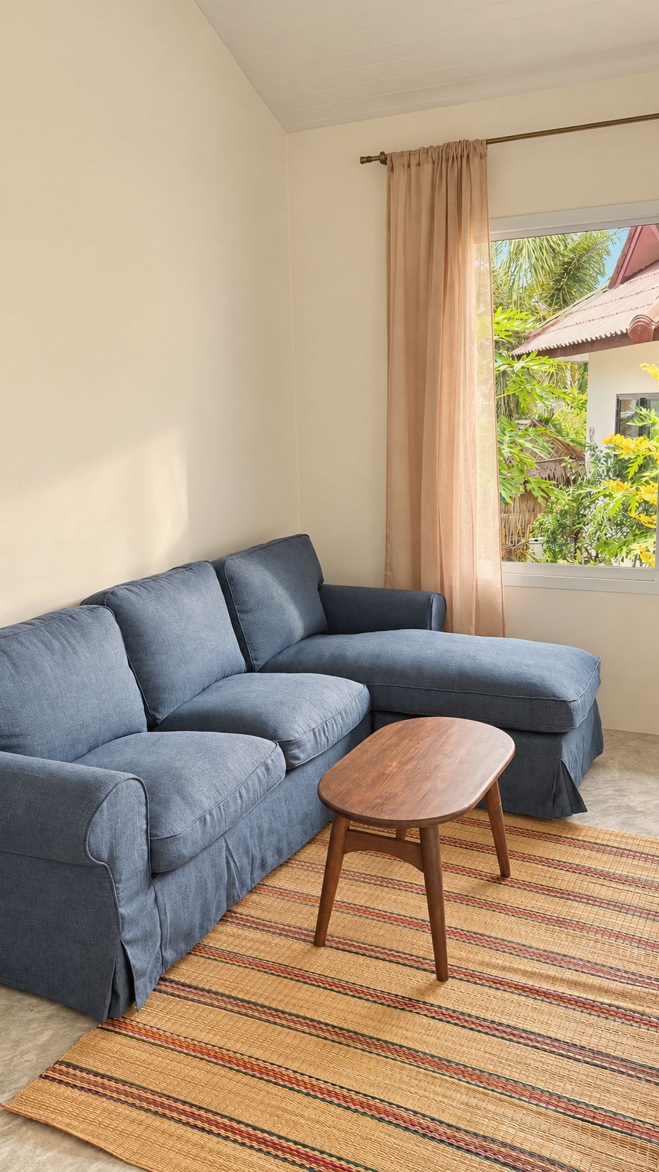 Blue linen sofa and wooden coffee table on a woven rug