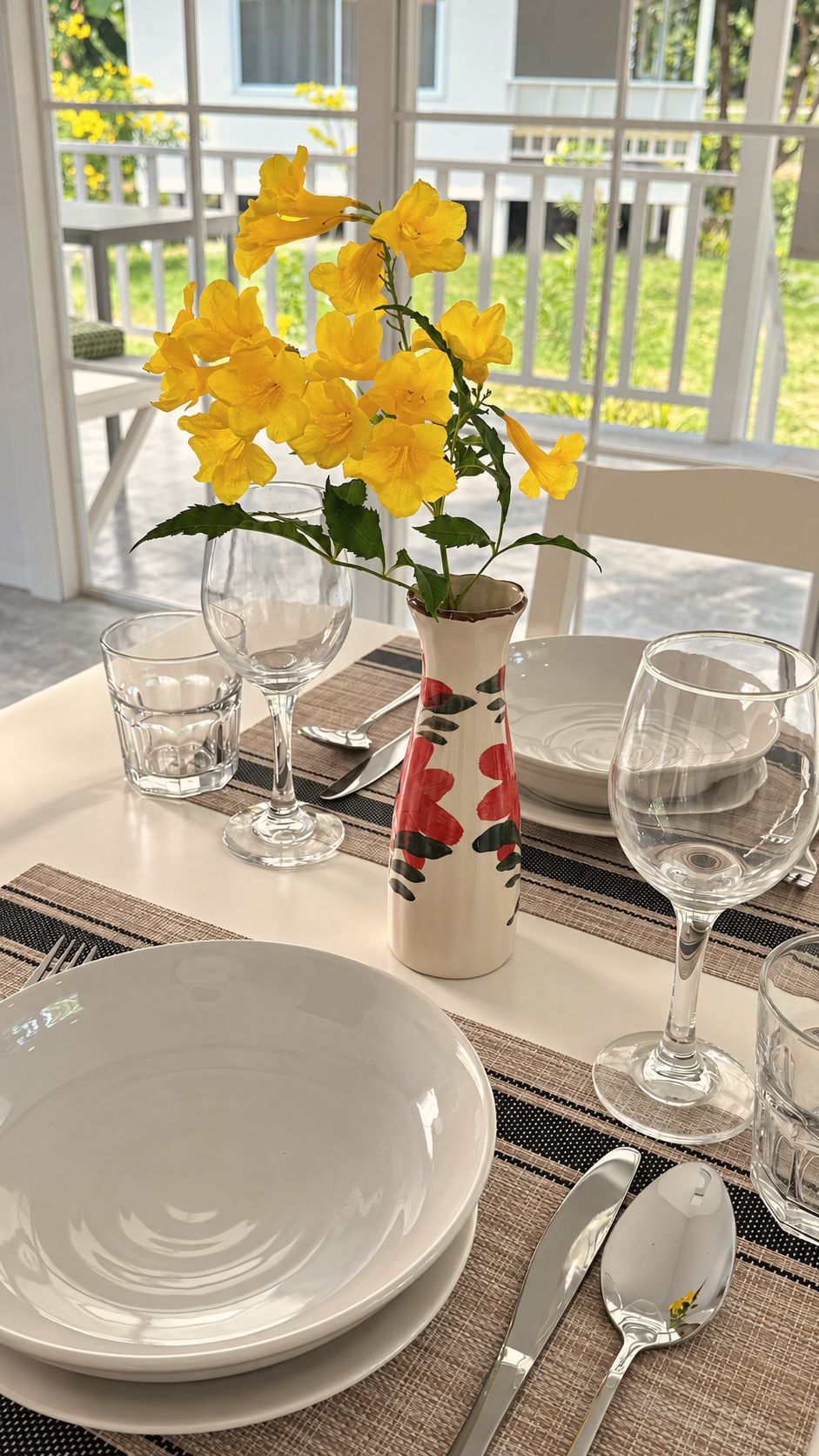 Breakfast table set with yellow flowers