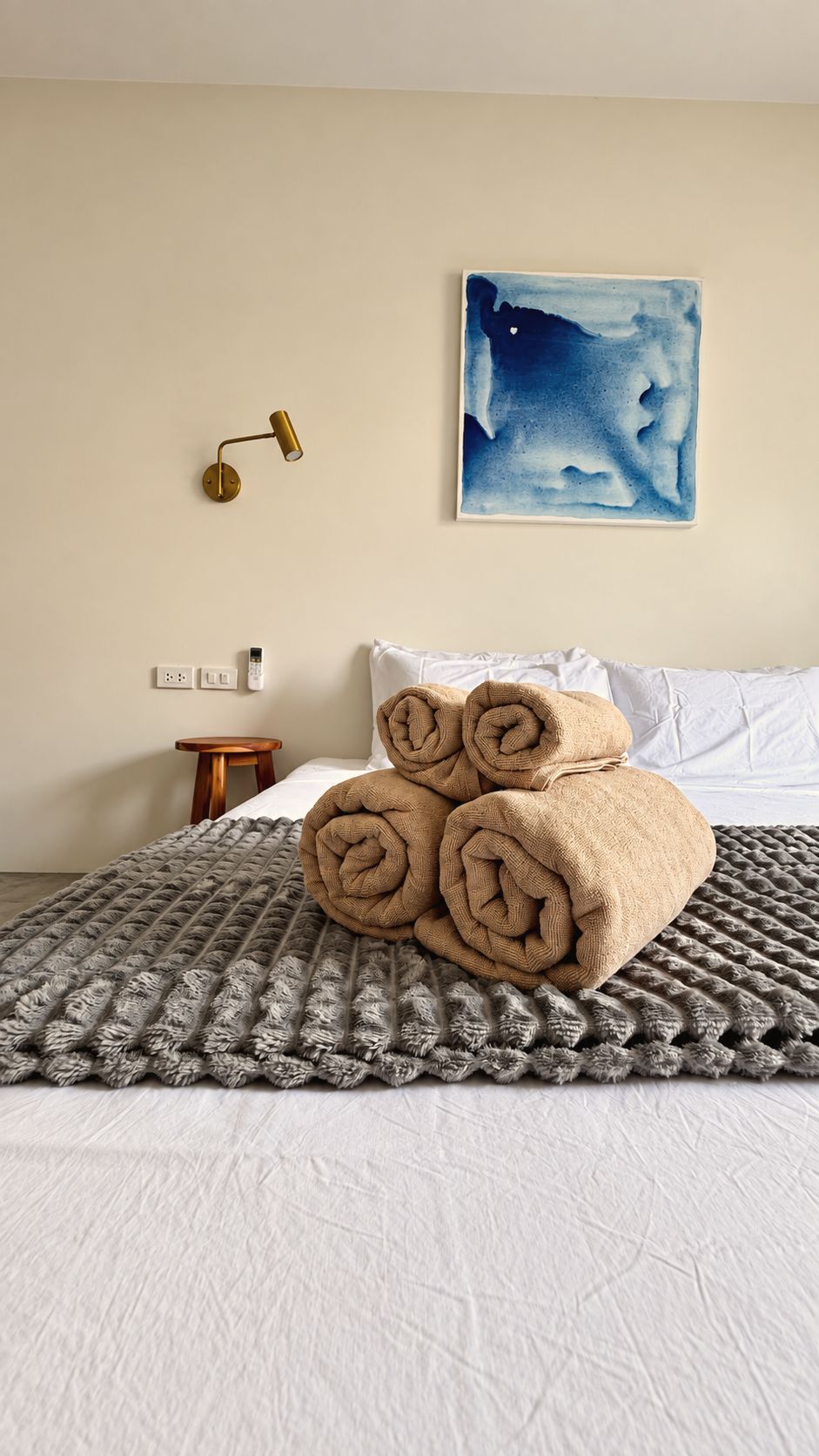 Rolled towels on a woven throw